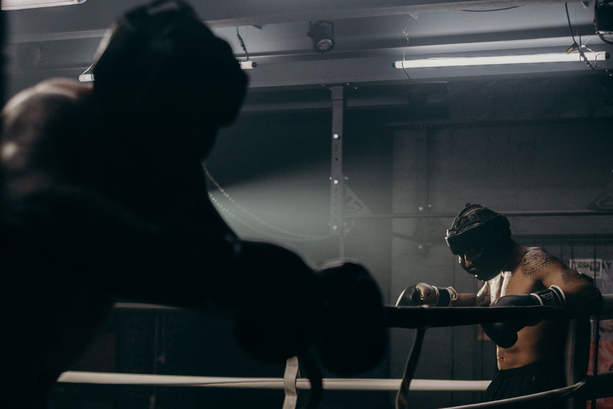 Two fighters sparring in a dimly lit ring